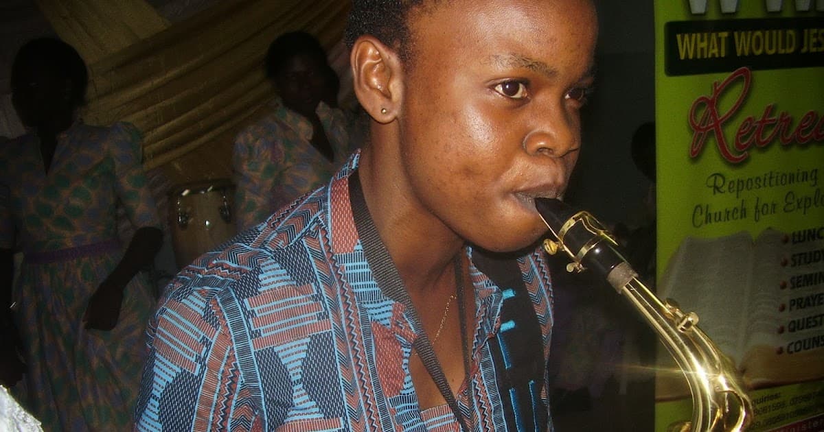 Young Funmilayo playing saxophone at church