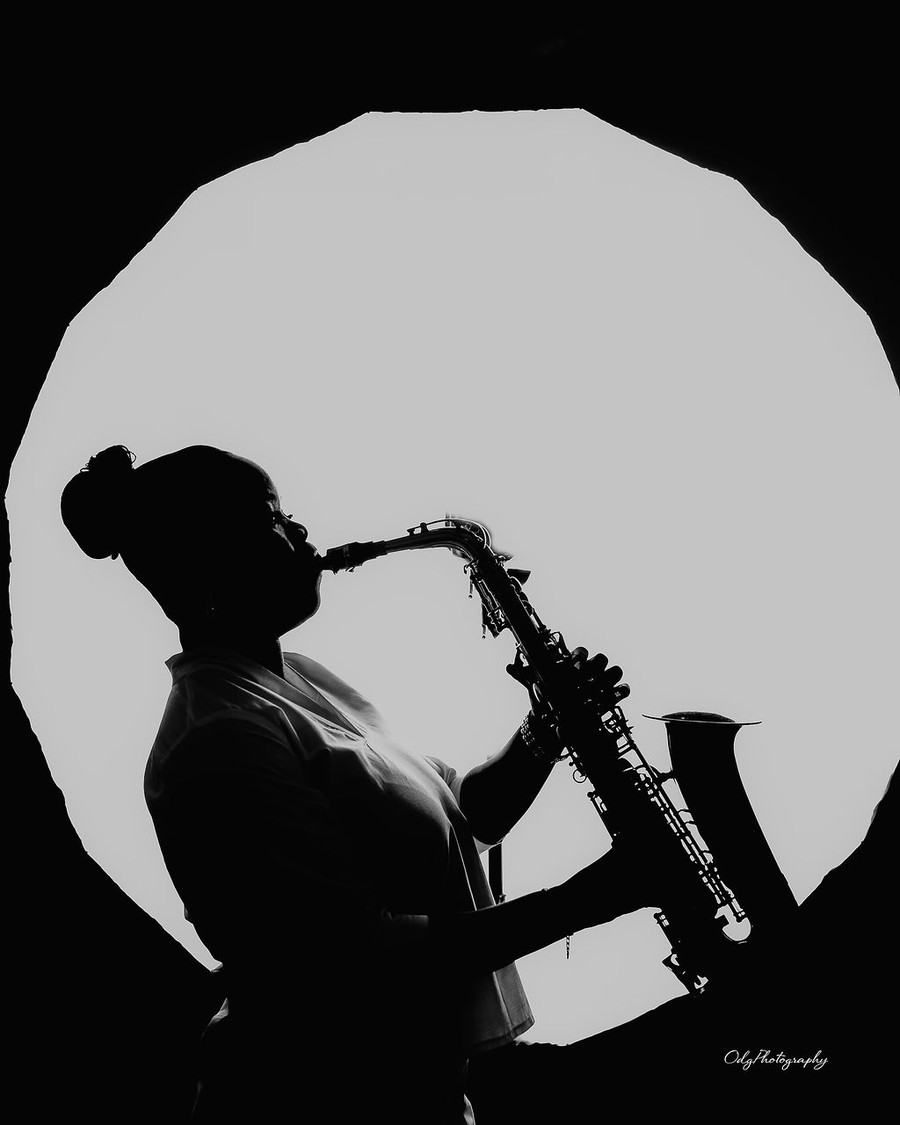 Silhouette of Funmisax playing the saxophone