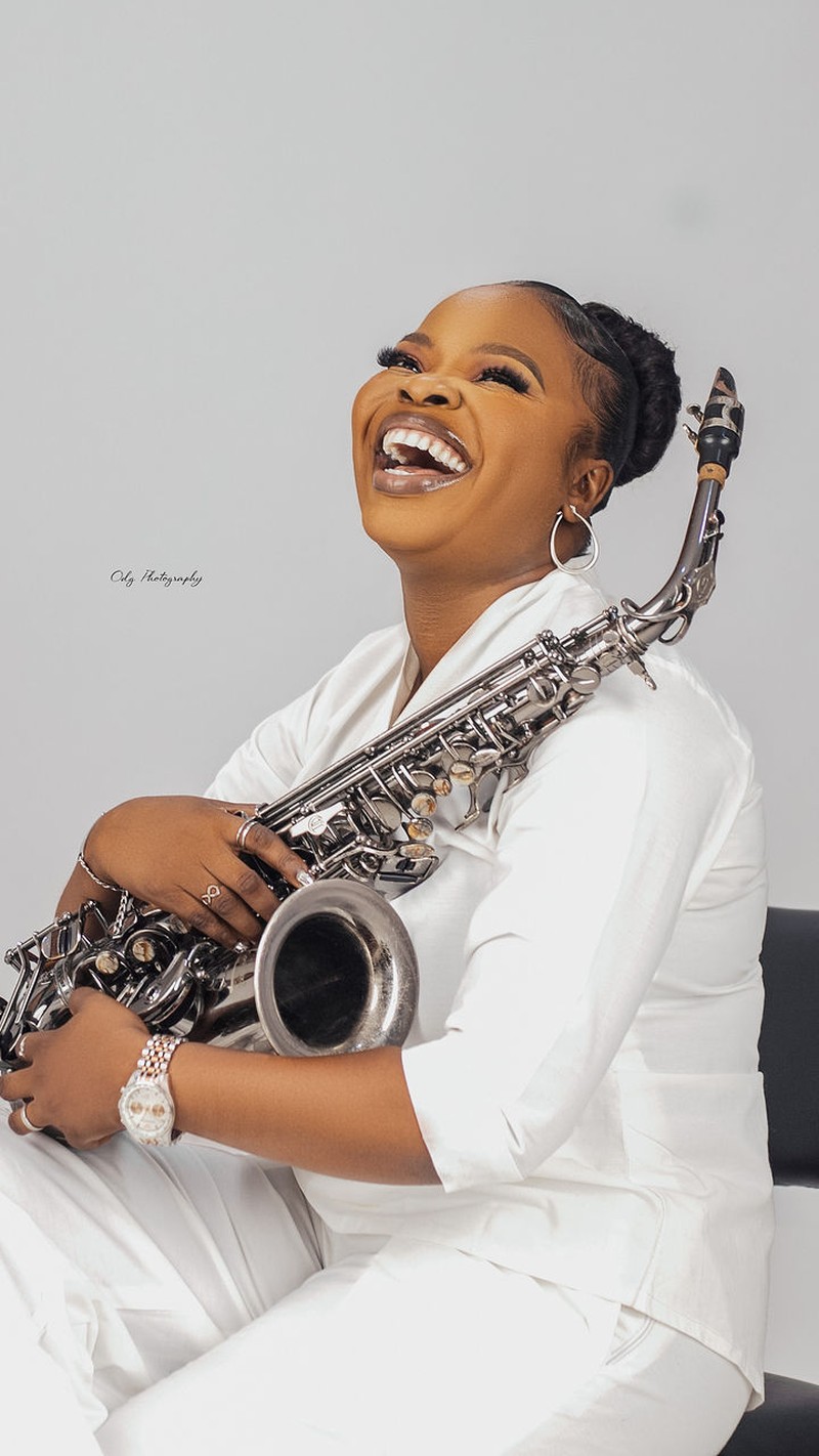 Funmisax laughing with her saxophone