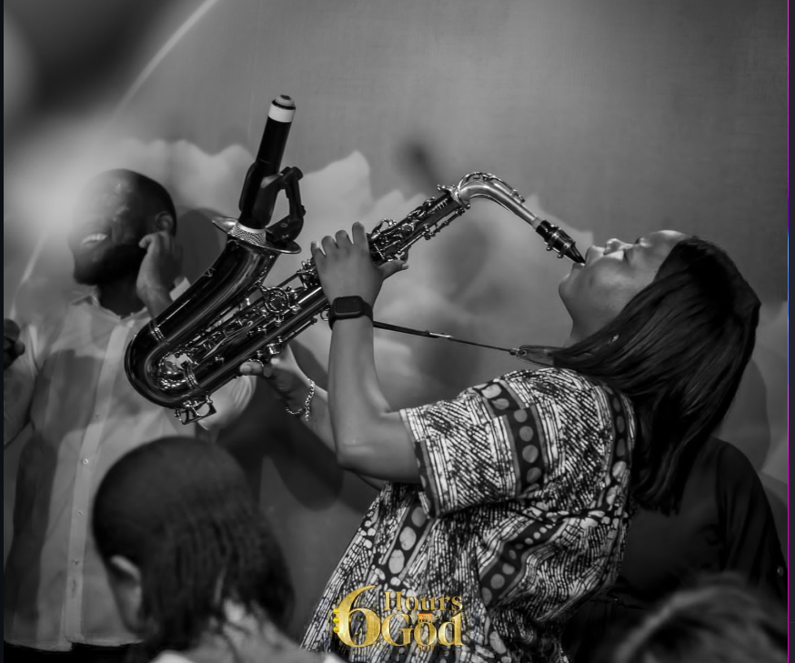 Funmisax lost in worship with her saxophone — black & white
